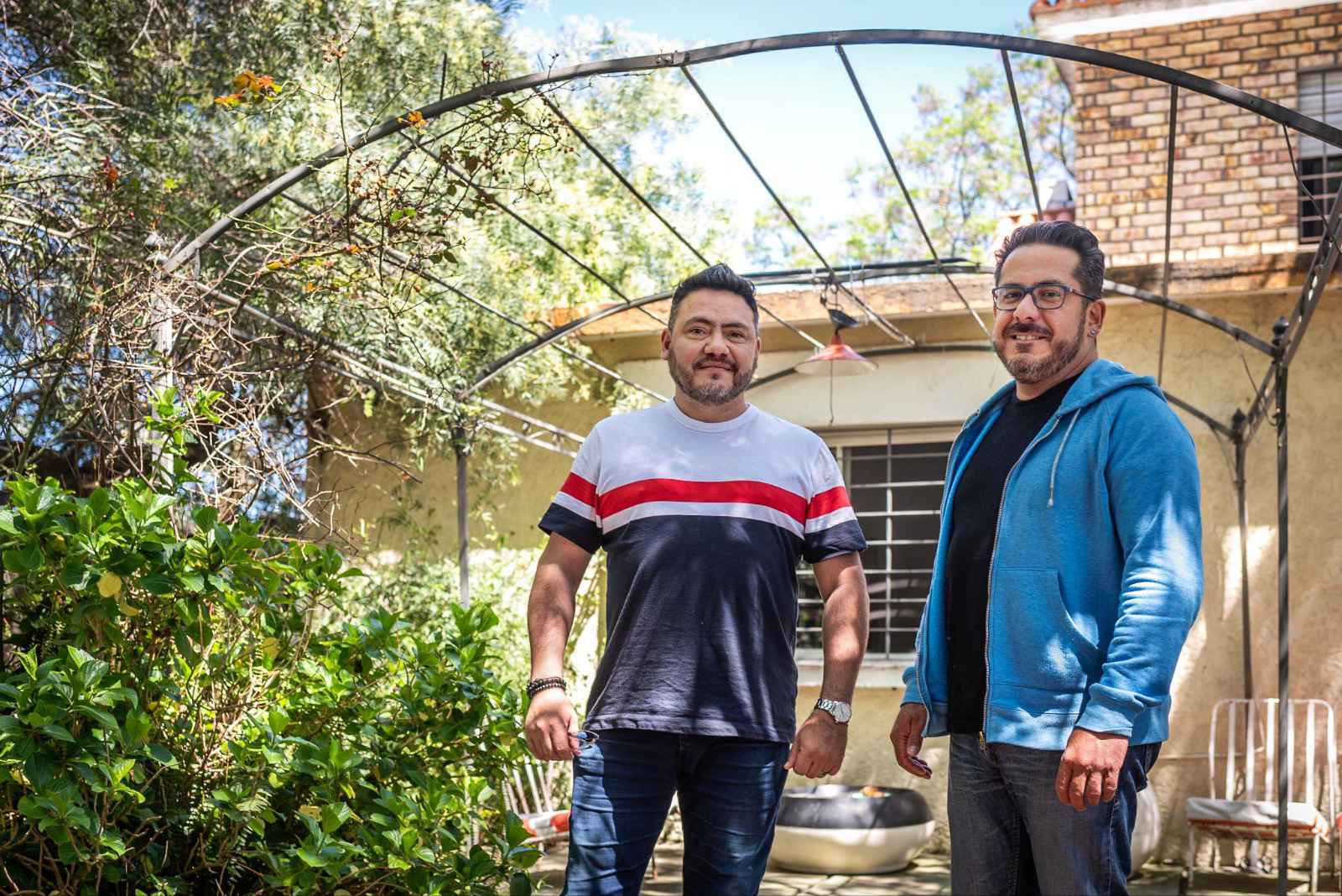 Two men standing together outdoors in a garden, reflecting on long-term recovery and aftercare support.