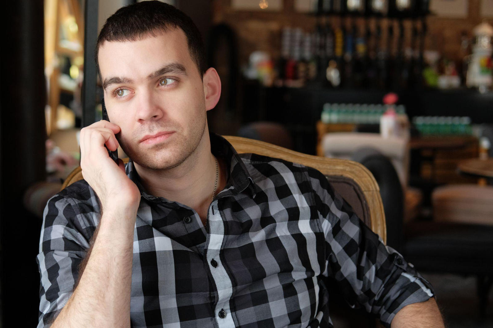 A man talking on his smartphone to learn more about residential addiction recovery programs.