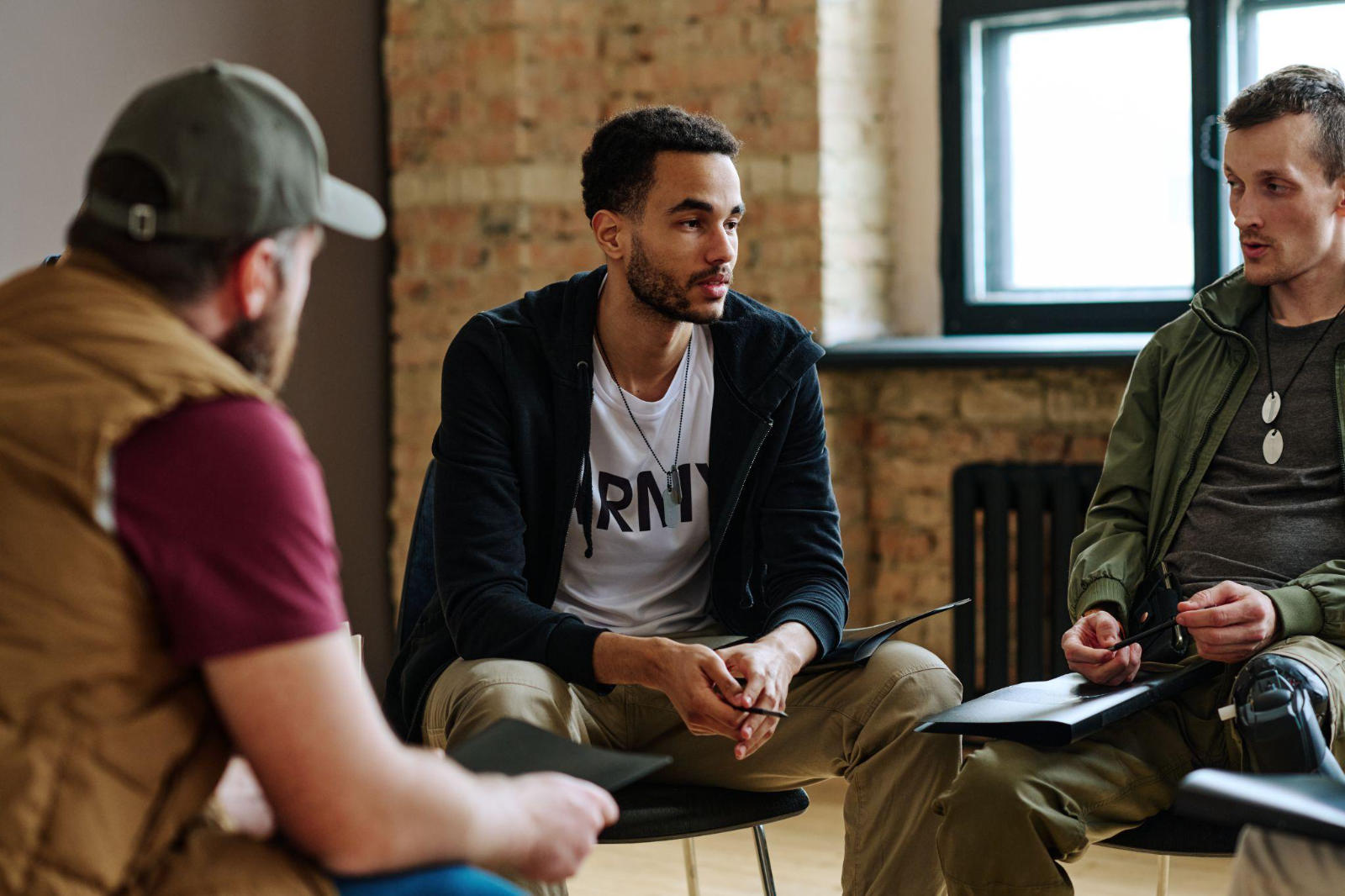 residential-addiction-treatment-bc-group-support A group of men sitting in a circle during a support meeting at a residential addiction treatment centre in BC.