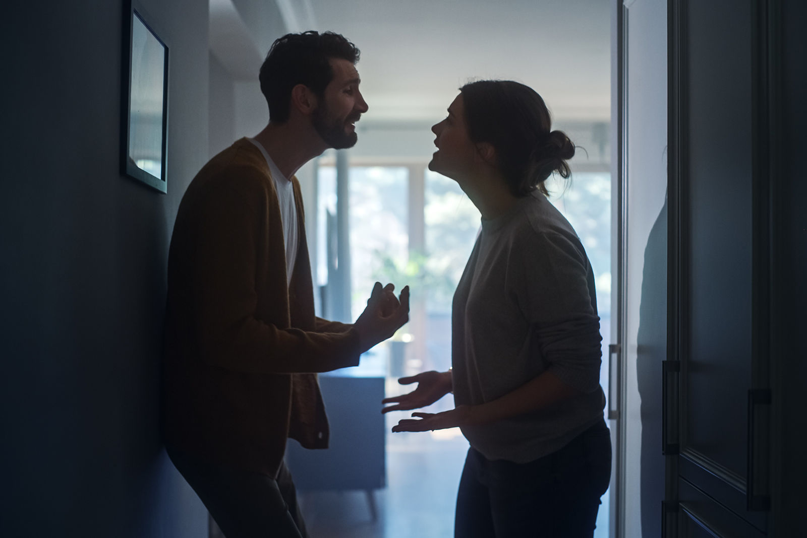 A man and woman having a heated argument in a hallway, demonstrating how drug and alcohol addiction affects personal relationships.